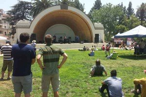 People standing and sitting in front of a stage