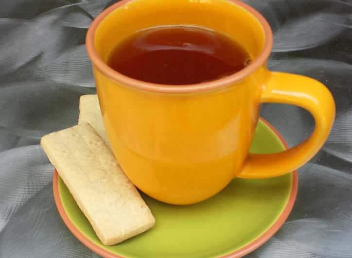 A cup of tea with cookies
