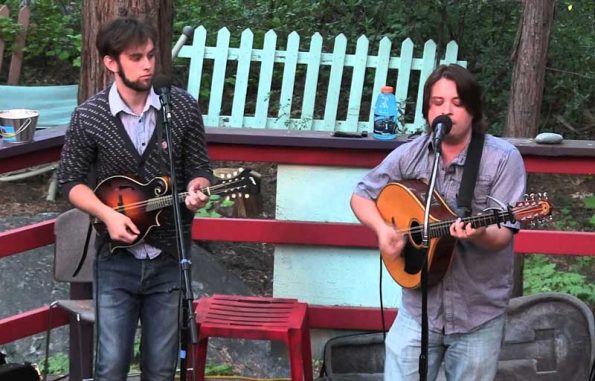 two guys singing in a park