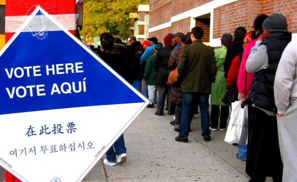 Standing in long lines waiting to vote (Photo - commons.wikimedia.org)..
