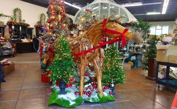 A horse display with christmas decorations around it