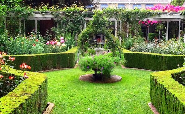 A manicured lawn with a fountain in the middle