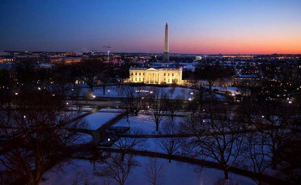a building with snow in sunset with purple and pink colors