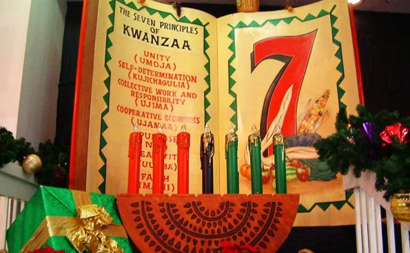 7 colored candles in front of a book