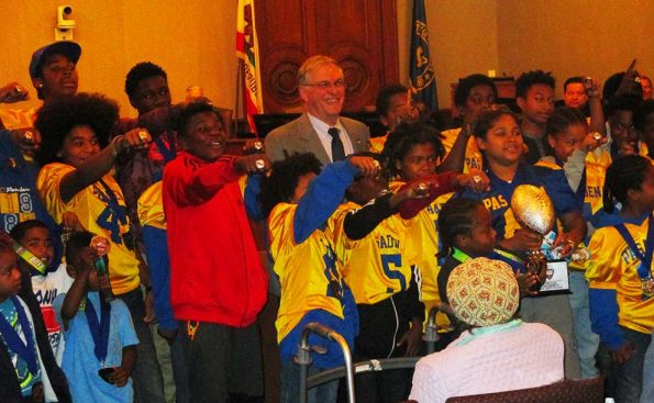 Mayor Terry Tornek poses with members of Pasadena's AAU football team (Photo - Garrett Rowlan).