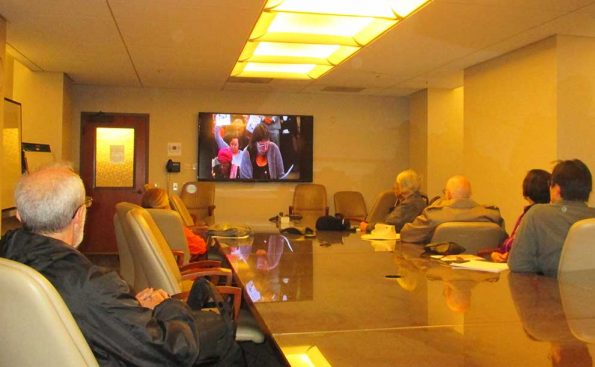 People watching the City Council meeting at a conference room in the basement (Photo - Garrett Rowlan).