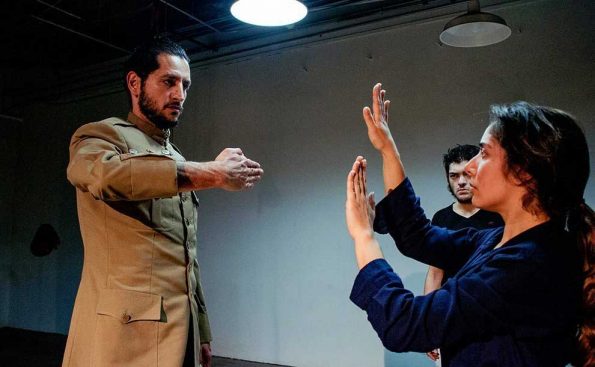 Hasiff Fadul in military outfit extends his hand in a threatning way at Corina Vela while Javier Balderas looks in horror