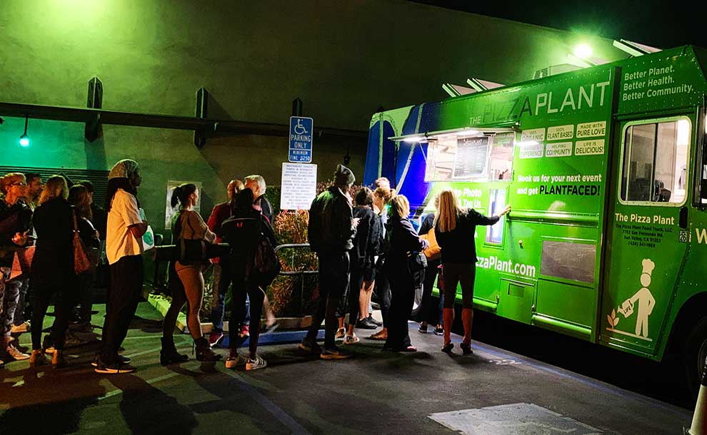 poeple lining up in front of a food truck