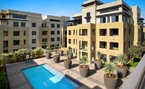 A newly constructed building with a pool