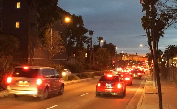 cars back to back next to residential building