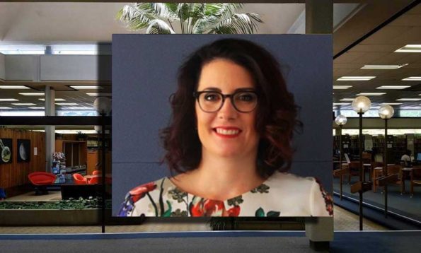 A woman with glasses and floarl shirt