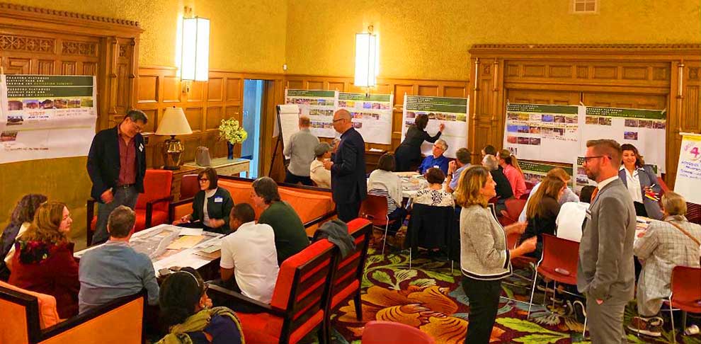 Group of poeple in groups and map displays around them