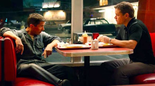 2 guys talking to each other at a diner