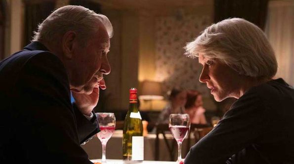 A woman and amantalking over wine