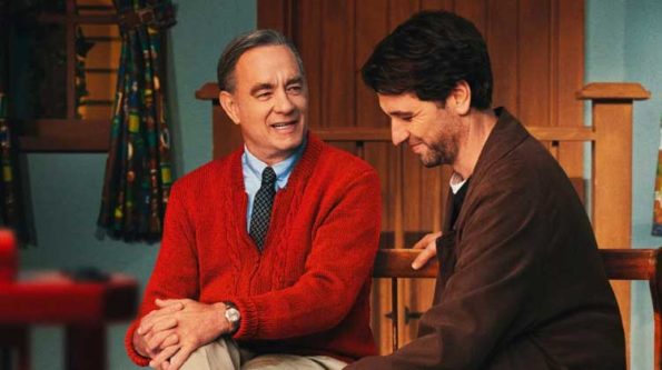 A man ina red sweater and another man in a brown shirt share a laugh