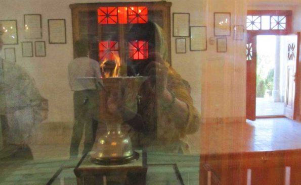 A woman photographing an urn