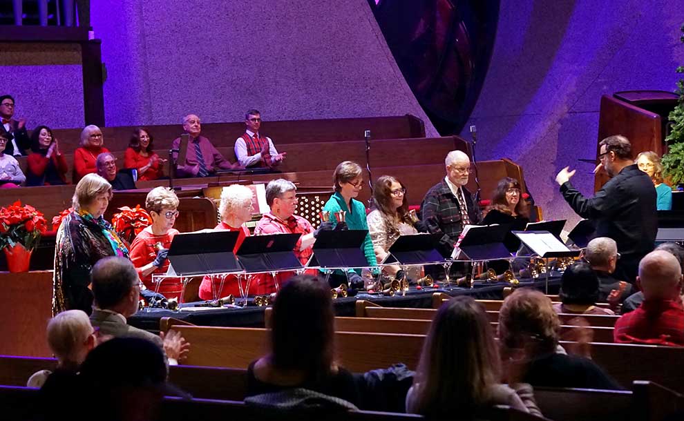 A male conductor leading a choir