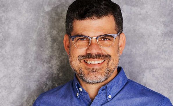 a man in blue shirt and glasses