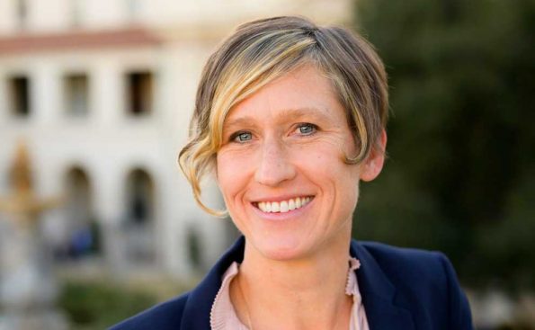 A white woman in a blue blazer