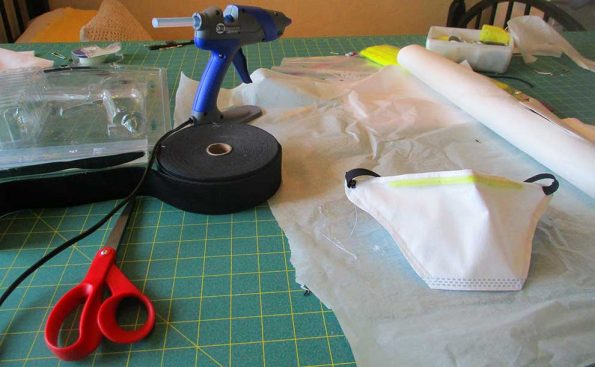 A mask, tape and scissors on a table