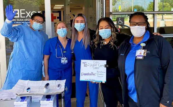 Nurses with masks wabing at camera