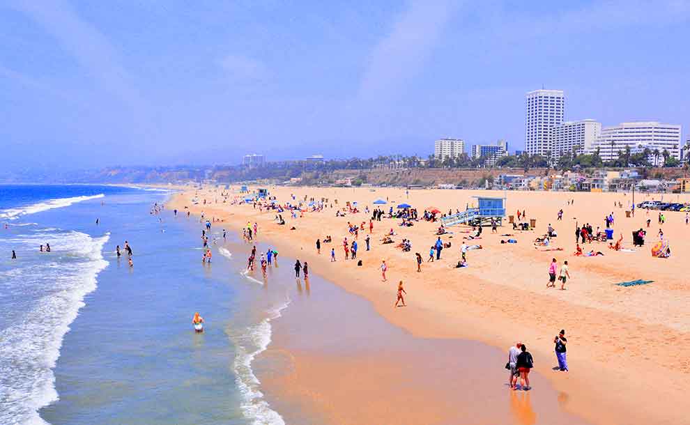 A beach with swimmers and endless shores