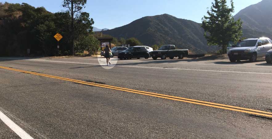 a person crossing a wide street