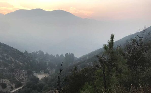 smoke engulfing tip of mountains