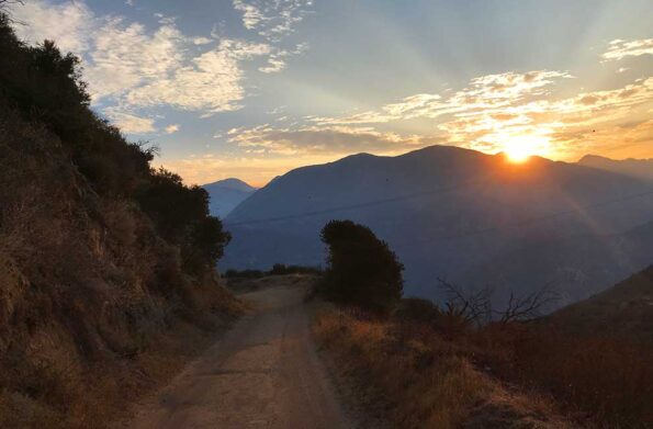 a sun rises from the moutain top