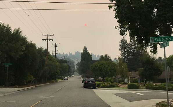 a smoky sky and orange sun