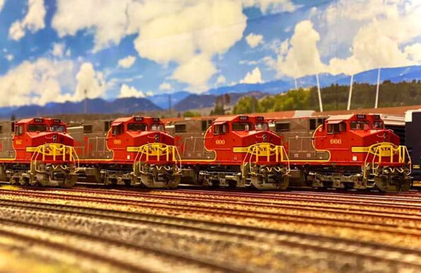 small scale trains lined up next to each other