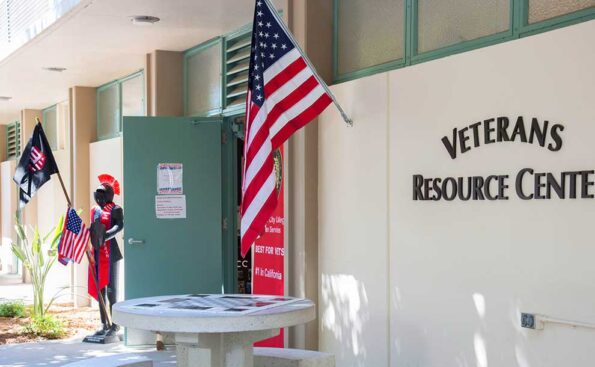 a flag and an armor holding military flag outside a center