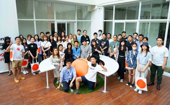 asian students holding bags with artcenter logo
