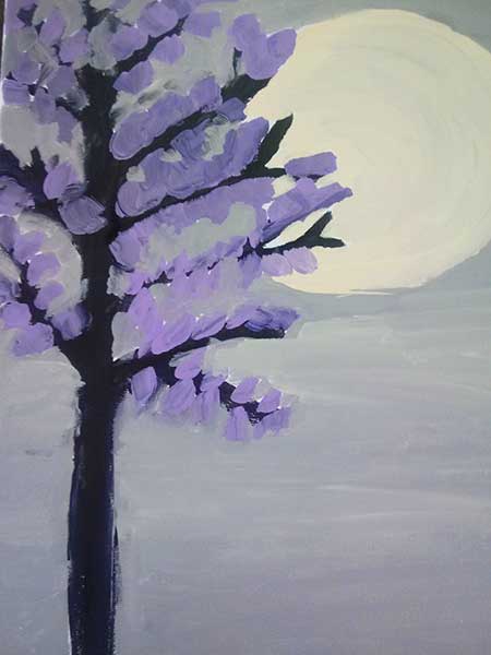 a tree with purple leaves and a mountain