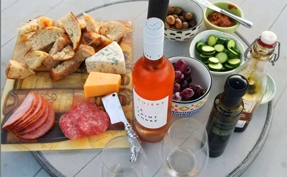 a platter of maza food and a wine bottle