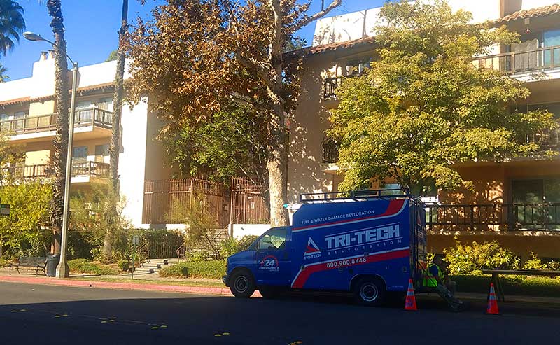 a van for fire fising in front of an apartment building