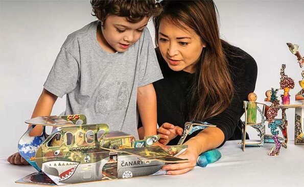 AnAsian mother and her son play with a paper toy