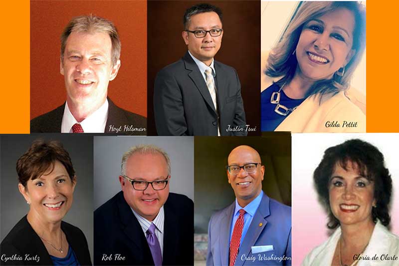 4 men and 3 women smiling at camera