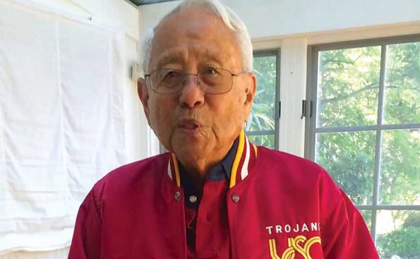 A man with white hair and USC jersey