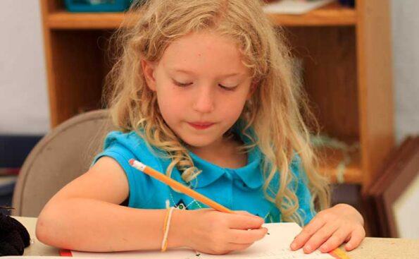 a white girl writing on a pad