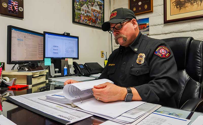 A man in uniform sitting at his desk
