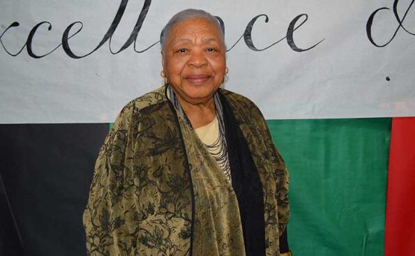 A woman with white hair smiling