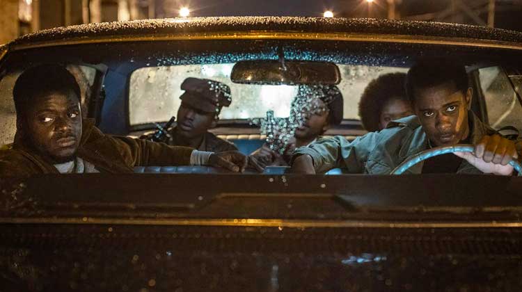 black men in a car while raining