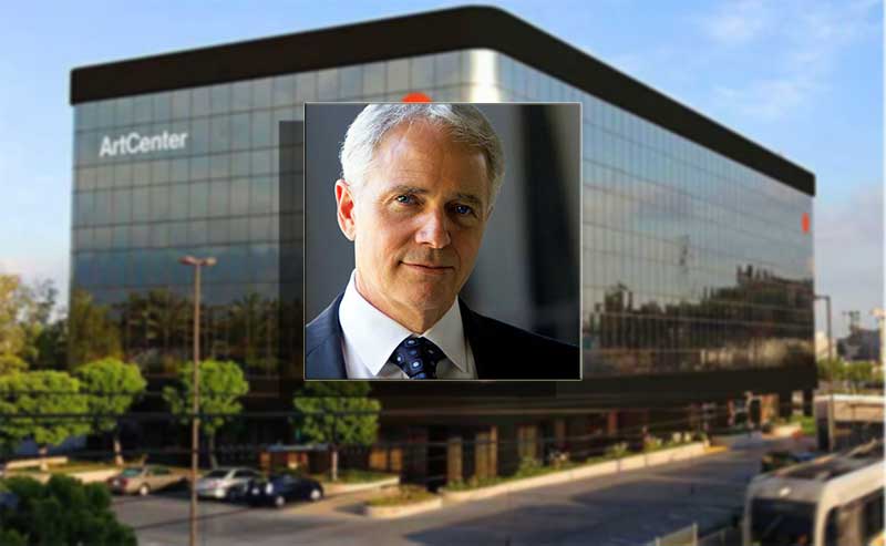 aman with white hair over a building