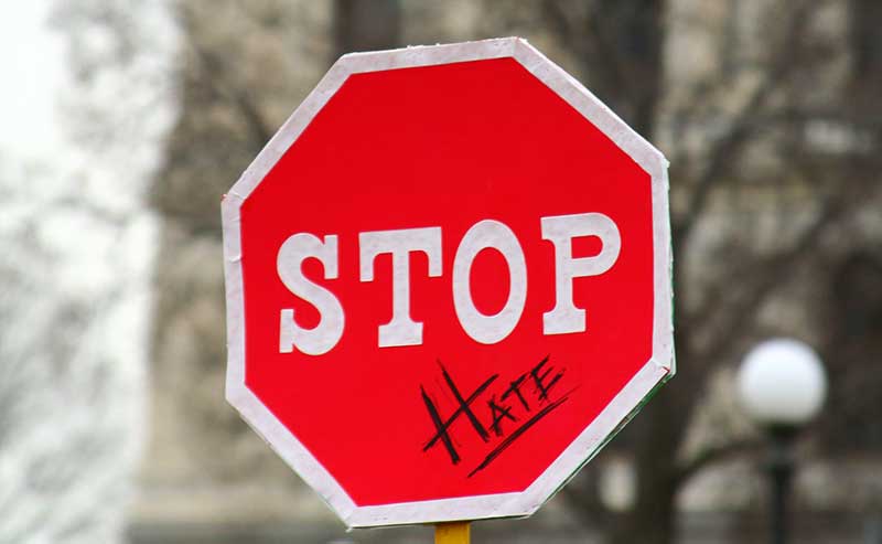 a stop sign and the word hate pplaced underneath it