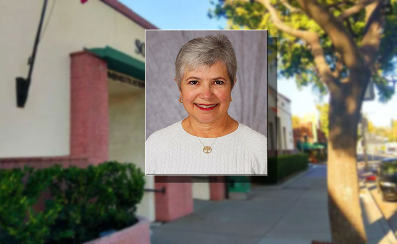 a woman in a blouse smiling