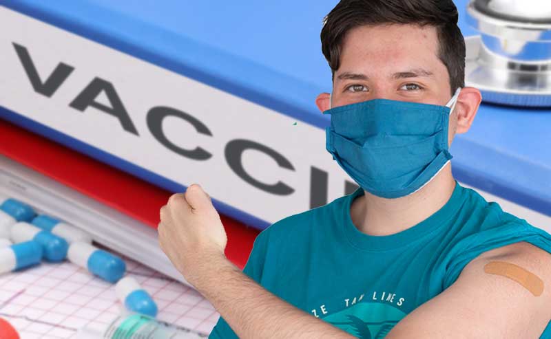 a guy with his arm extended to show vaccination