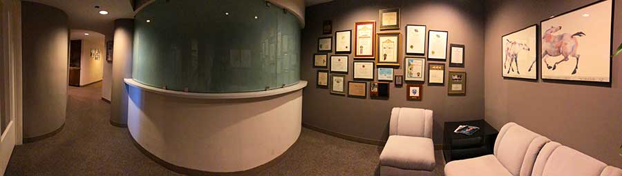 a lobby with glass and sofas