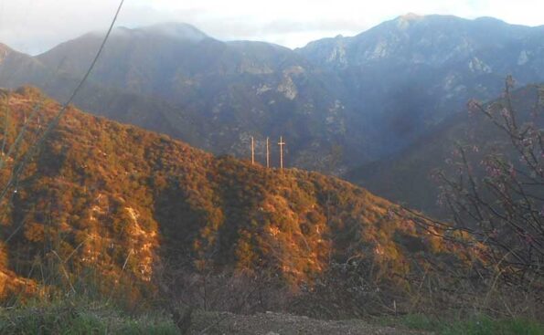 three utility poles that look like crosses