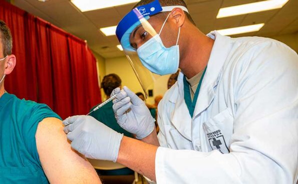 a doctor vaccinating a patient